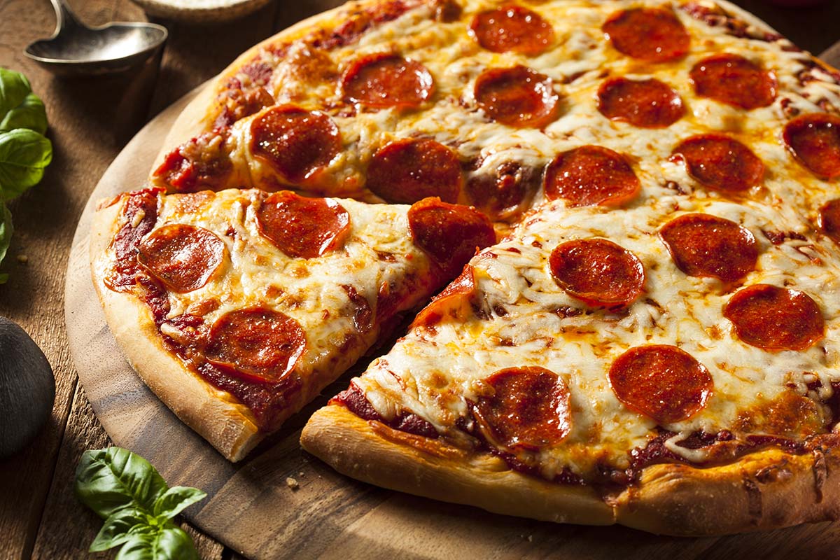 pepperoni pizza on a wooden board. 