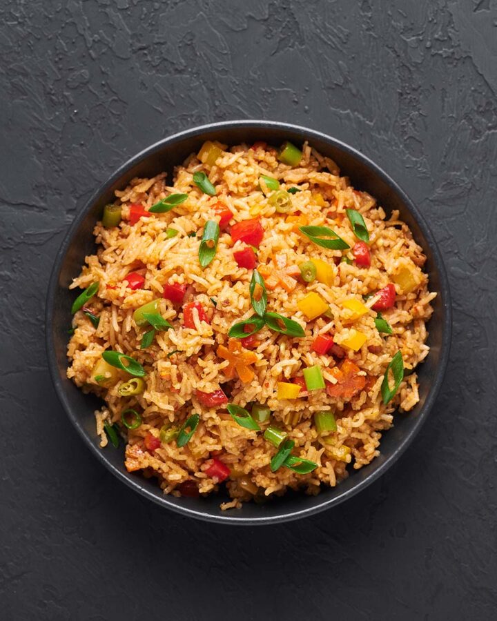 yellow rice with vegetables in a bowl.