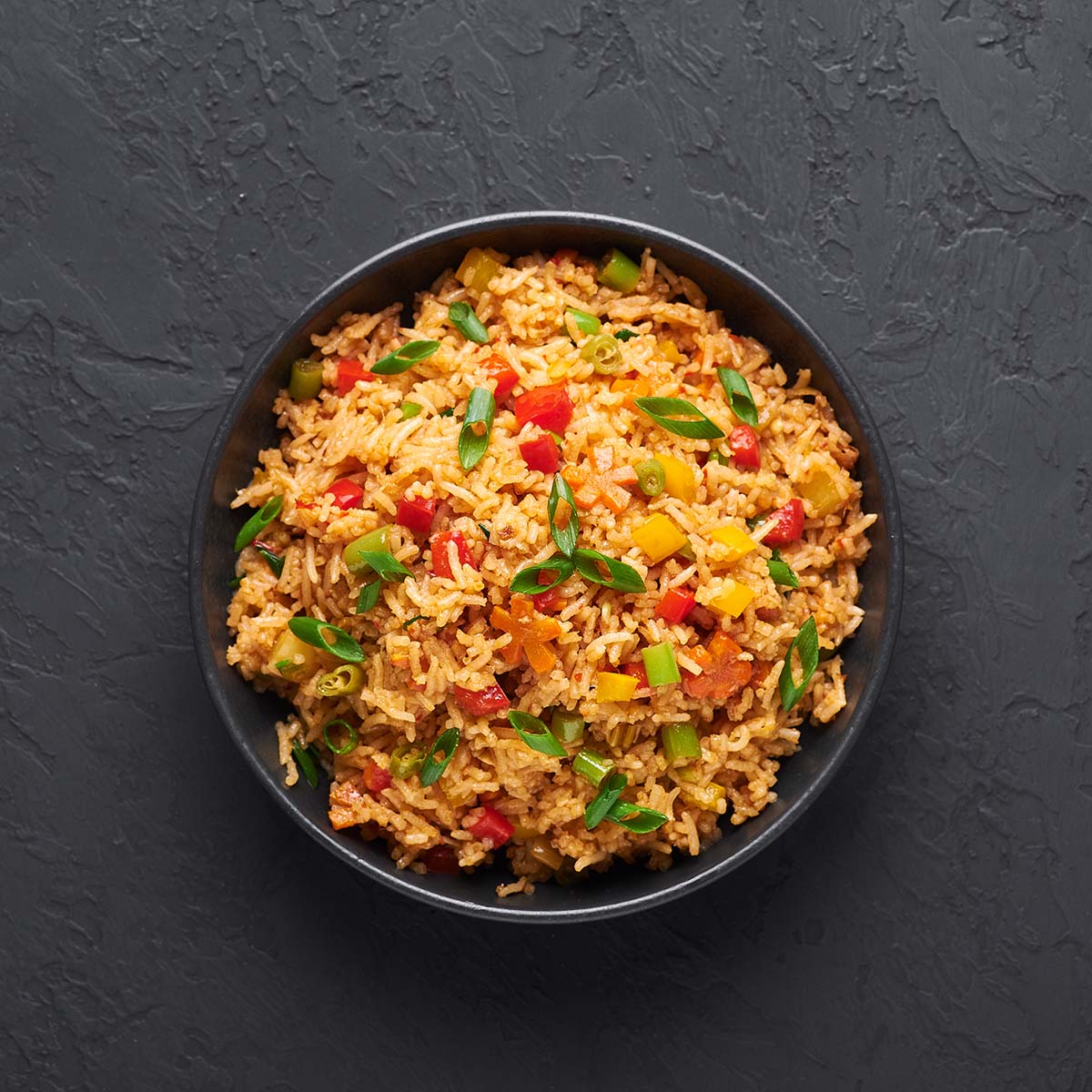 yellow rice with vegetables in a bowl. 