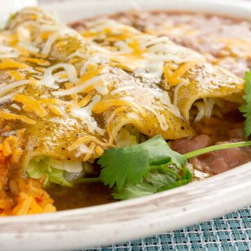 crepini enchiladas with yellow rice and beans.