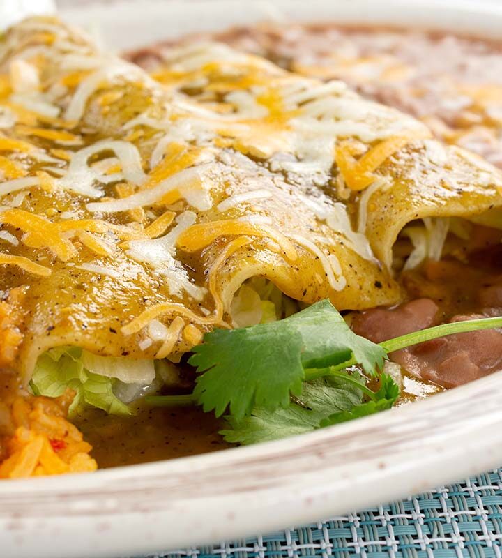 crepini enchiladas with yellow rice and beans.