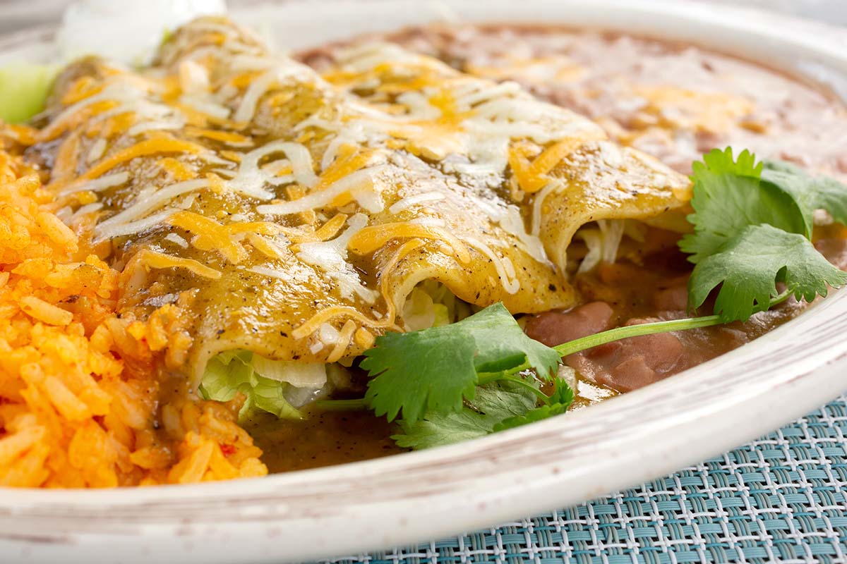 crepini enchiladas with yellow rice and beans.
