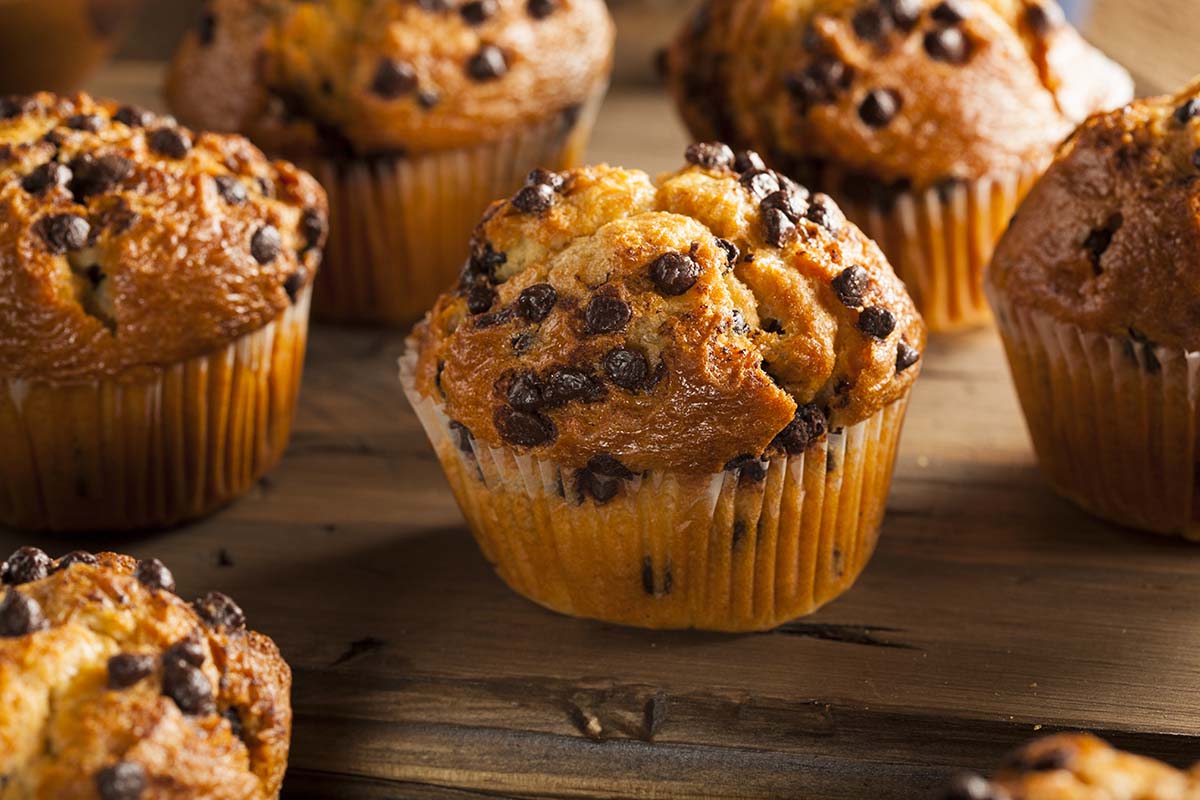 gluten free chocolate chip muffins on a wooden board. 