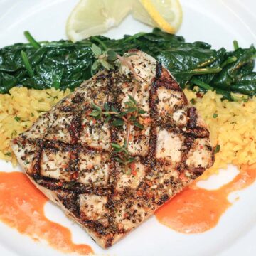 grilled wahoo with yellow rice, sauteed spinach, and lemon.