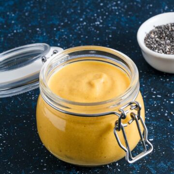yellow creamy cashew sauce in a glass jar.