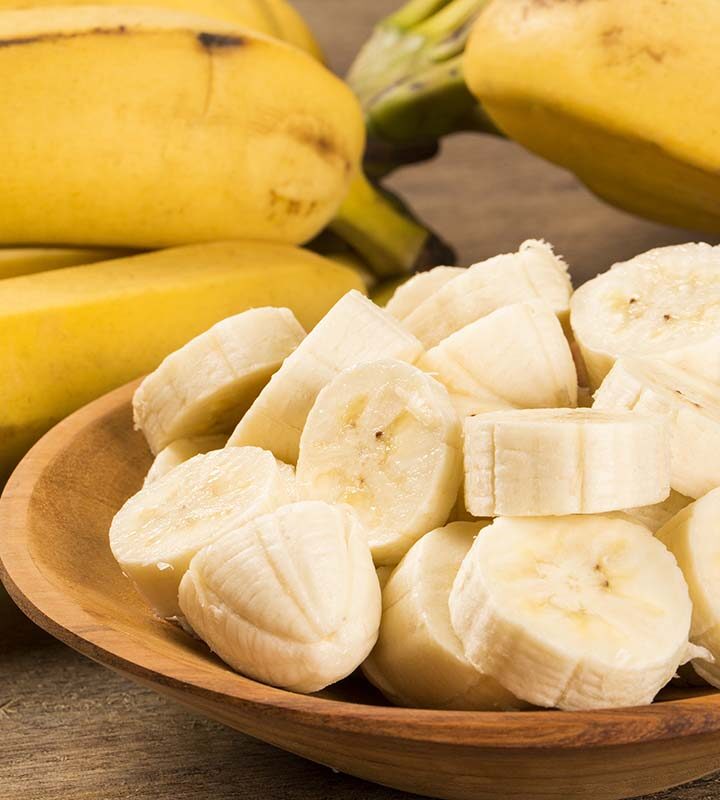 Sliced up bananas in a wooden bowl.