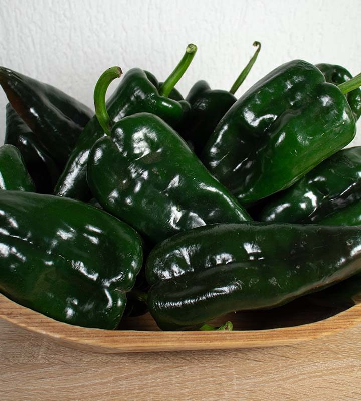 Poblano peppers in a wooden bowl.