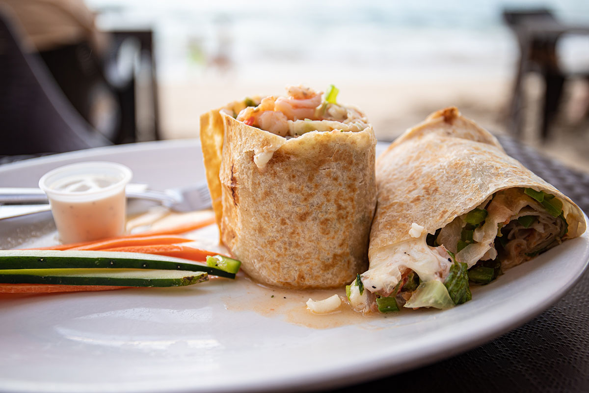 a shrimp burrito sliced in half.